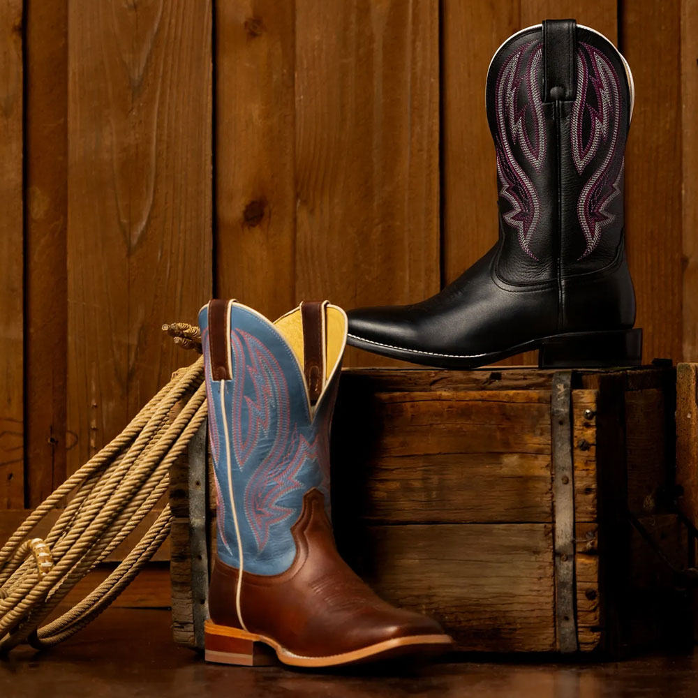 A half pair of Darcia 11” Western boots in brown and black set up on a box.